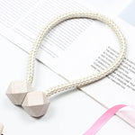 Side view of a pearl curtain tieback securing a thick curtain, demonstrating its versatility.