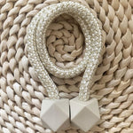 A pair of non-magnetic pearl curtain tiebacks displayed against a plain background.