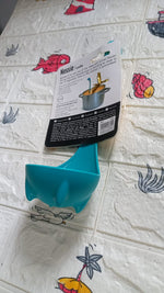 Multifunctional silicone soup spoon being used to strain vegetables from a pot.