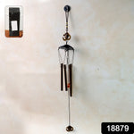 Close-up of metal wind chime with Om symbol showing tuned metal tubes