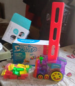 Transparent domino train engine creating a long, winding line of blocks.