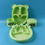 Kids feeding dinner set pieces arranged showing spoon, mug, bowl and plates