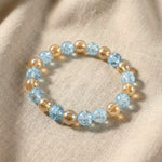 Close-up of glossy dual-tone beads on crystal stretch bracelet