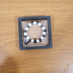 Elegant black and white beaded bracelet worn as fashion accessory
