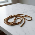 Brown spiral cable protector sleeve detail highlighting flexible cord saver