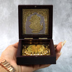 Video presenting golden Charan Paduka in wooden box used as devotional pooja accessory