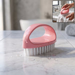 Pink handled scrubbing brush designed for deep cleaning tasks