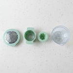 Top-down view showing various grating surfaces on manual vegetable grater