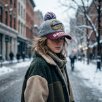 Close-up of winter woolen cap with pom pom showcasing soft knit fabric