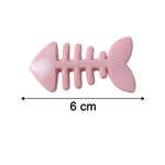 Cartoon hair clip displayed next to a ruler showing its compact size.