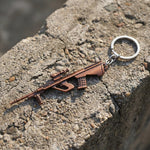 Side view of metal gun-shaped keychain accessory