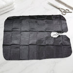 Professional hair cutting apron cape hanging on hook