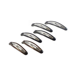 Multiple snap hair clips arranged for versatile hair styling