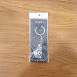 Lifestyle image of silver finish Bal Krishna keychain attached to car keys