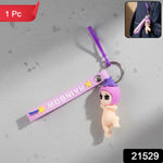 Decorative baby doll silicone keychain hanging from a bag strap