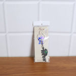Lifestyle image showing Radha Krishna Radhe Radhe keychain in use
