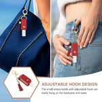 Open faux leather sanitizer holder keychain showing clear refillable bottle