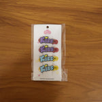 Woman wearing a Kiss text hair clip in long flowing hair