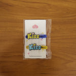 Model wearing Kiss cartoon letter snap hair clips as playful accessory