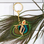 Side view of Krishna metal keychain highlighting flute and peacock feather motif