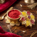Close-up of ornate golden pooja kumkum box