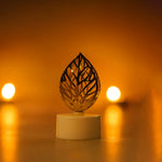 Golden leaf LED candles illuminating a festive setting, creating a serene ambience.
