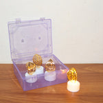Overhead shot of multiple golden leaf LED candles in a warm, inviting display.
