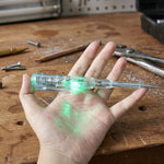Digital voltage tester pen detecting electricity on electrical outlet with LED lights