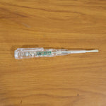 Digital voltage tester pen in use detecting a live wire with LED indication