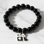 Black beaded stretch bracelet with an adorable panda charm on white background.