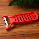 Dual-function grater and peeler tool by Supermom for fresh ginger