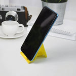 Foldable plastic phone stand in use holding smartphone securely