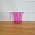Plastic bathroom mug in a modern bathroom setting.