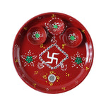 Three diyas arranged on vibrant hand-painted pooja thali for festivals
