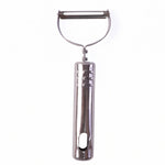 Stainless steel peeler on kitchen counter with peeled vegetables