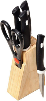 Stainless steel kitchen knives set with black handles arranged on wooden block