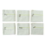 Six saree storage zipper pouches arranged for wardrobe organization