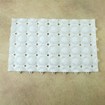Person standing on textured anti-slip massage bath mat