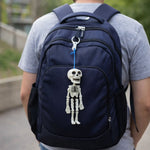 Skeleton doll keychain shown as a playful toy keyring