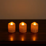 Safe flameless LED tealight candles with glitter finish on shelf