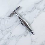 Stainless steel coconut breaker tool set displayed on a white background