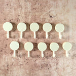 Self adhesive round wall hooks holding small hanging items