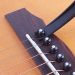 Musician demonstrating the Wagtail guitar capo's convenient integrated pick holder.