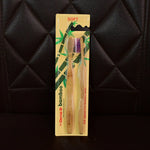 Angled view highlighting bamboo toothbrush with medium bristles