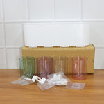 Plastic wall toothbrush rack with four inverted cups and grooming accessory slots