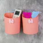 Close-up view of butterfly design wall-mounted toothbrush holder with two toothbrushes inside