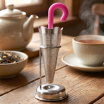 Close-up of the ergonomic hook handle on the stainless steel tea strainer for easy placement.