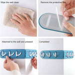 Wall-mounted foldable hook rack holding kitchen towels and cooking utensils