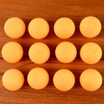 Orange table tennis balls ideal for training and tournament use displayed