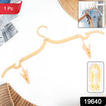 Clothes hanging on adjustable folding hanger with secure clips